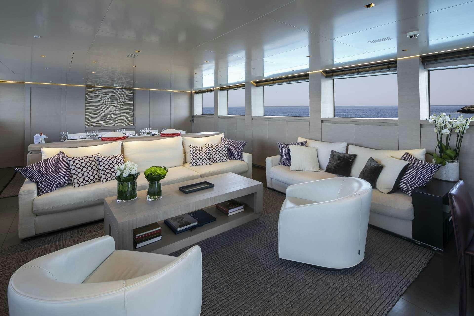 a living room with a couch and a coffee table aboard BILLA Yacht for Charter