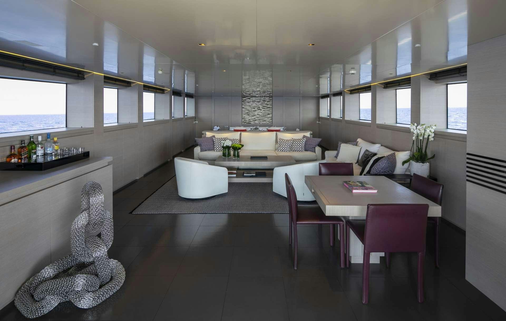 a living room with a couch and a table aboard BILLA Yacht for Charter