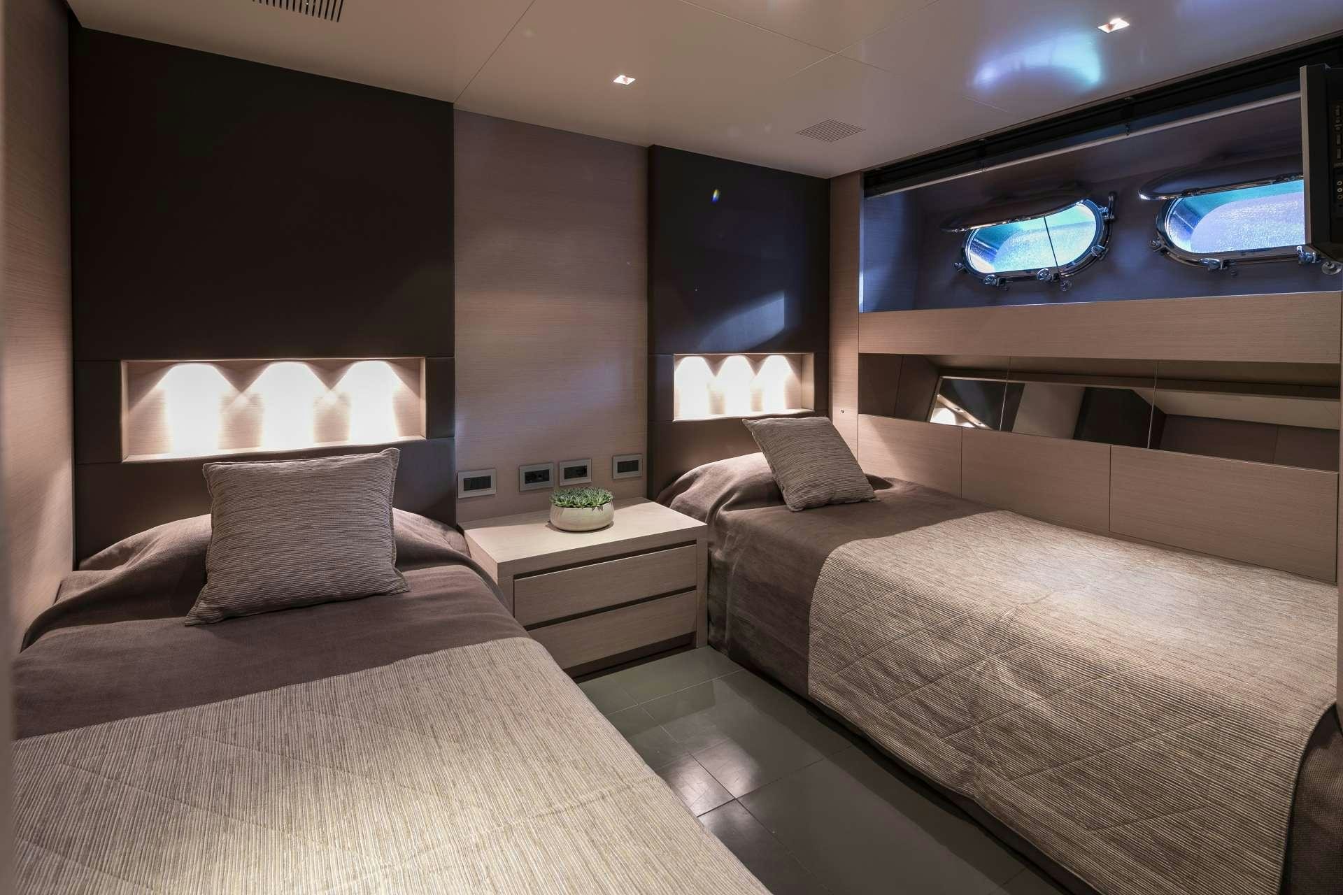 a room with two beds aboard BILLA Yacht for Charter