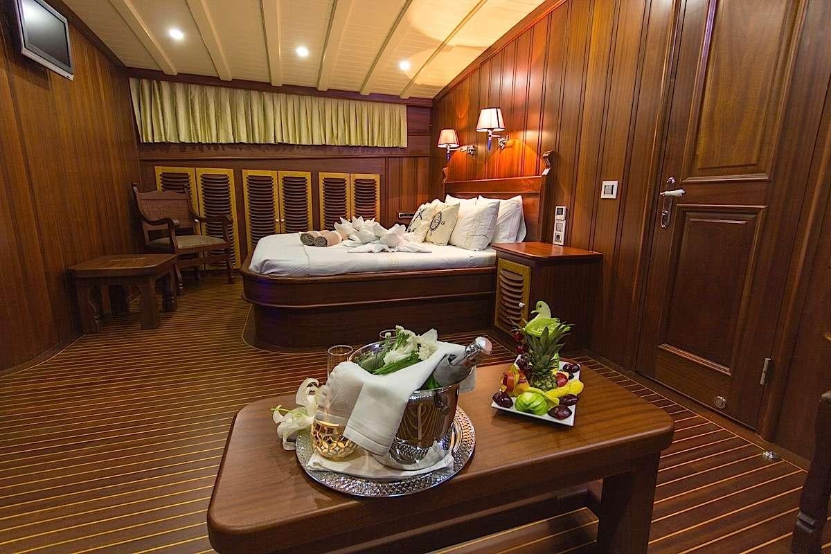 a living room with a large bed aboard PRINCESS KARIA II Yacht for Charter