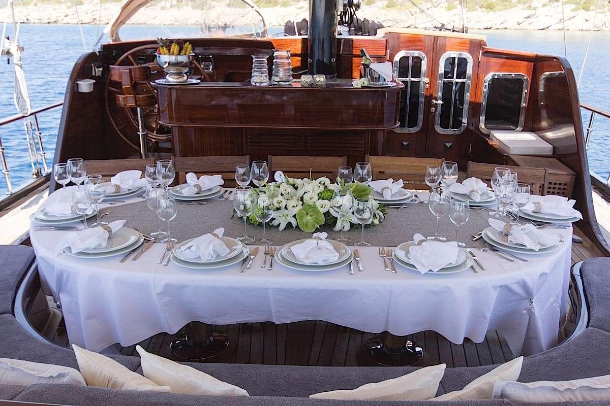a table set for a dinner aboard PRINCESS KARIA II Yacht for Charter