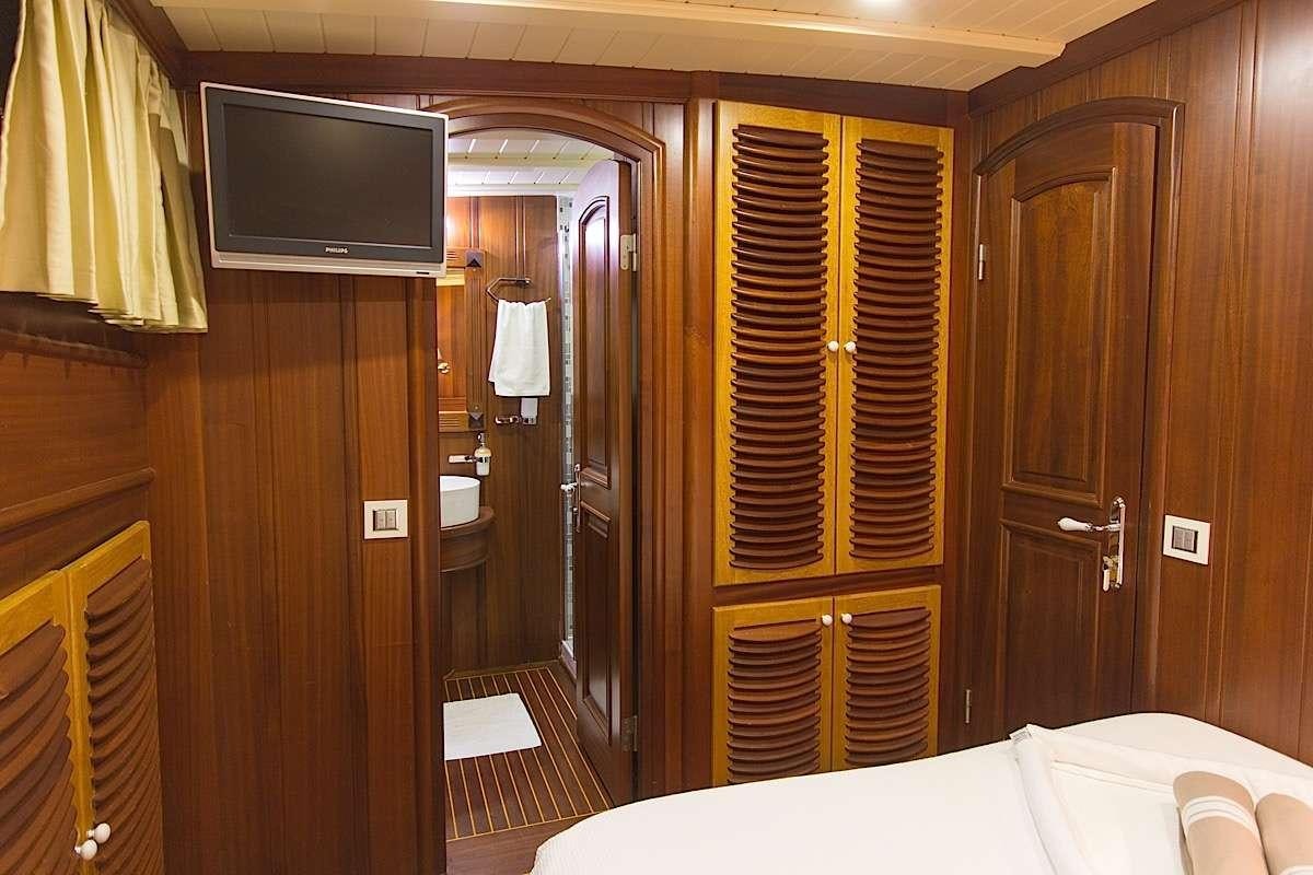 a bathroom with a large wooden closet aboard PRINCESS KARIA II Yacht for Charter