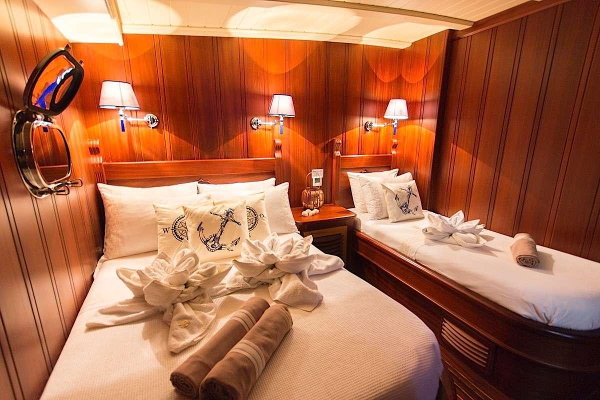 a hotel room with two beds aboard PRINCESS KARIA II Yacht for Charter