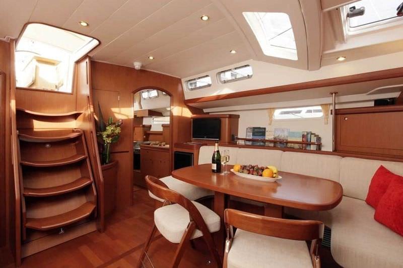 a kitchen with a table and chairs aboard CAPRICE Yacht for Charter