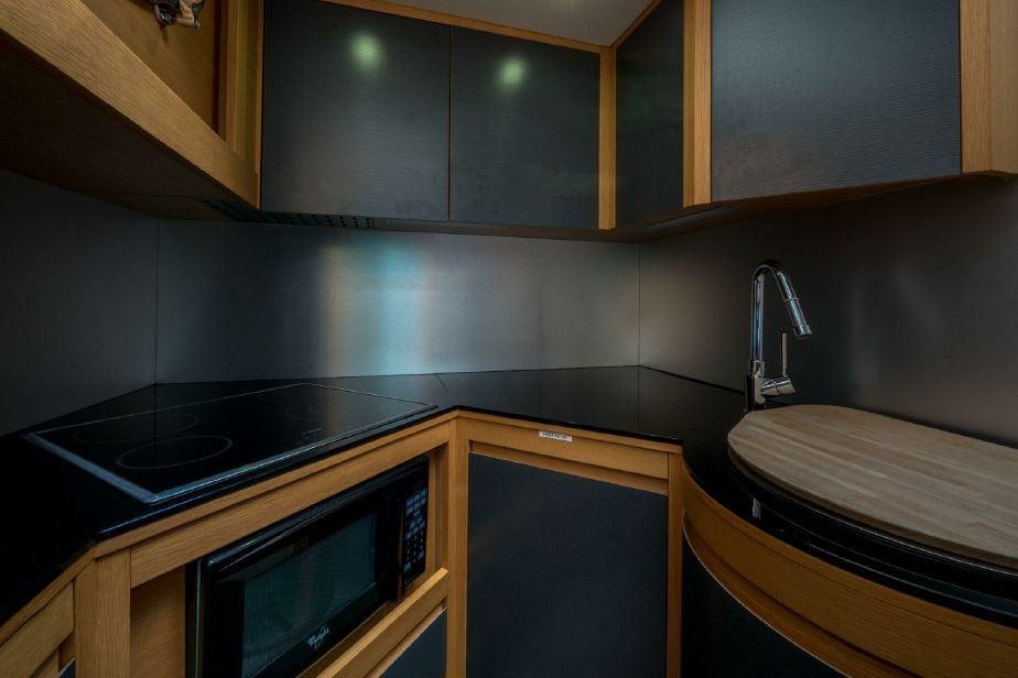 a kitchen with black counter tops aboard TICUN Yacht for Charter