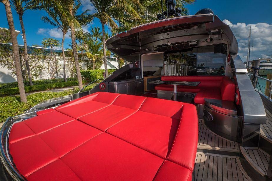 a red car parked on a wooden deck aboard TICUN Yacht for Charter