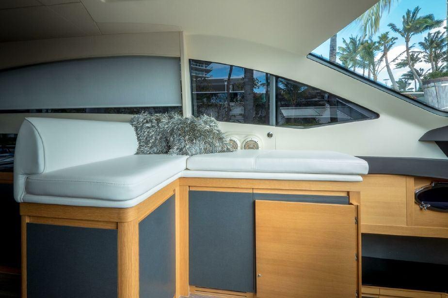 a white desk with a plant on it aboard TICUN Yacht for Charter