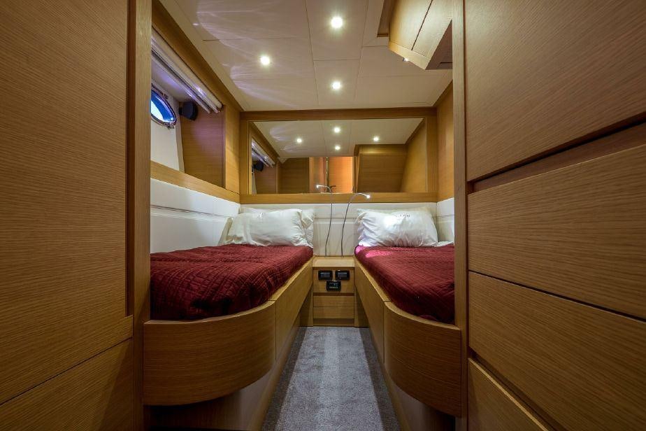 a room with a bed and a mirror aboard TICUN Yacht for Charter