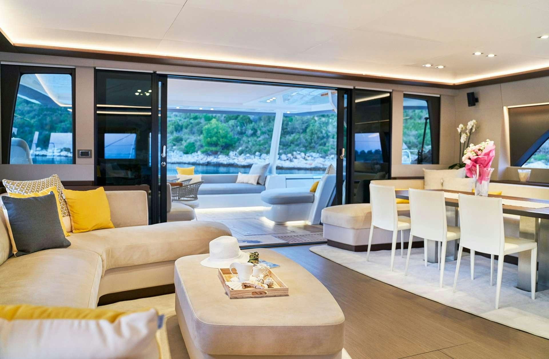 a living room with a large window aboard ADRIATIC DRAGON Yacht for Charter