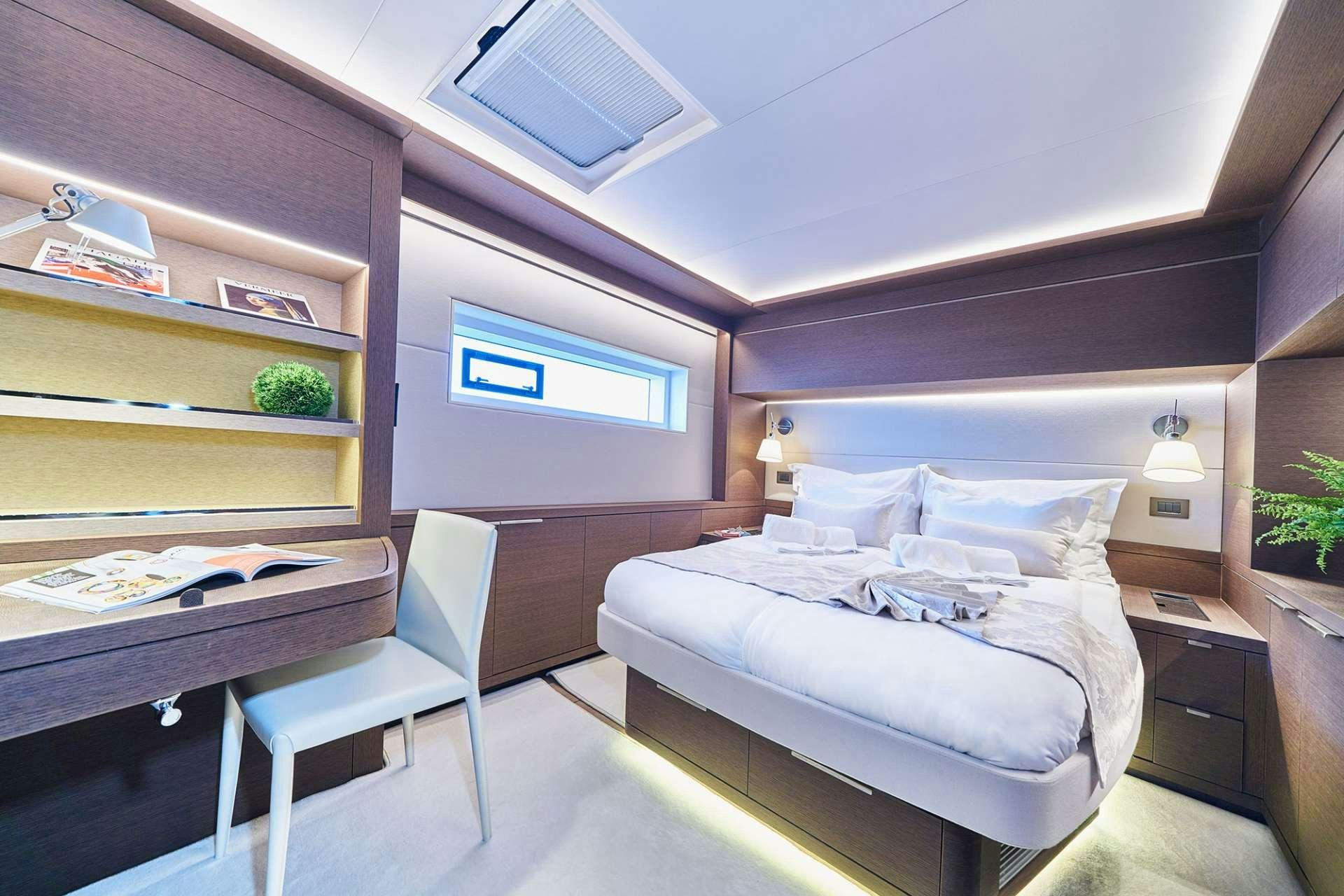 a bedroom with a bed and a desk aboard ADRIATIC DRAGON Yacht for Charter