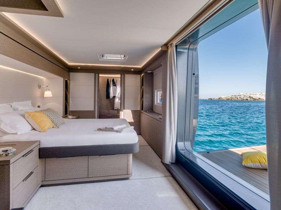 a room with a bed and a view of the ocean aboard ADRIATIC DRAGON Yacht for Charter