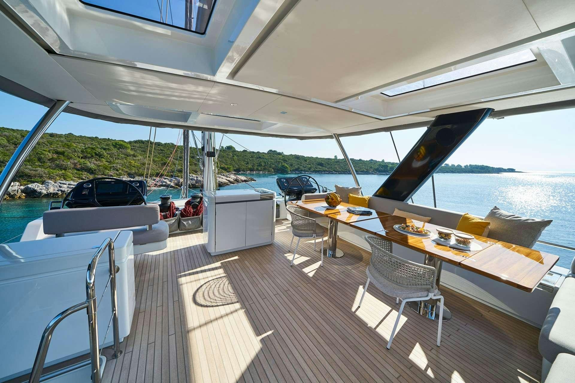 a boat with a table and chairs aboard ADRIATIC DRAGON Yacht for Charter
