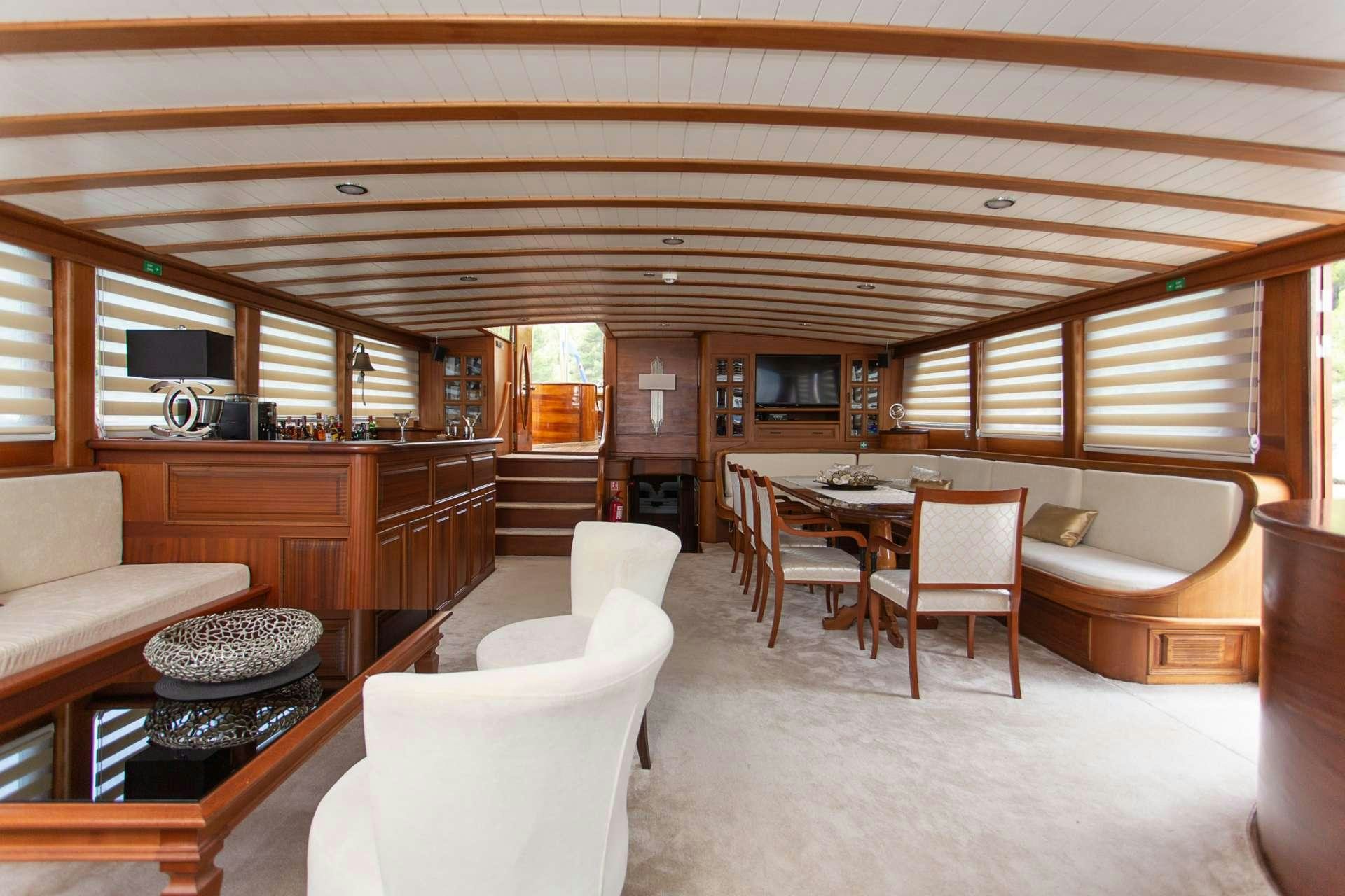 a large living room with a kitchen and dining area aboard DOLCE VITA Yacht for Charter