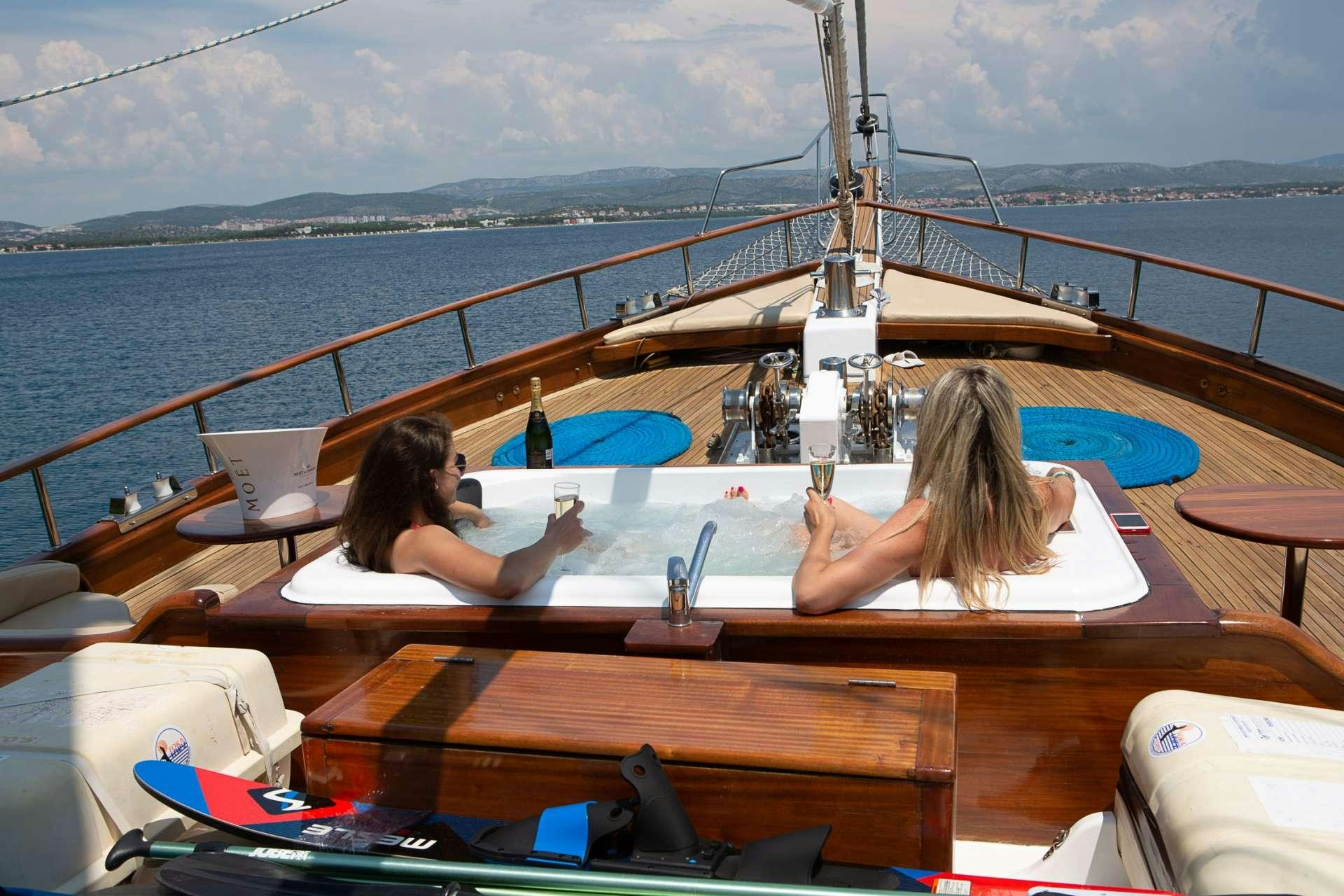 a couple of women sitting on a boat in the water aboard DOLCE VITA Yacht for Charter