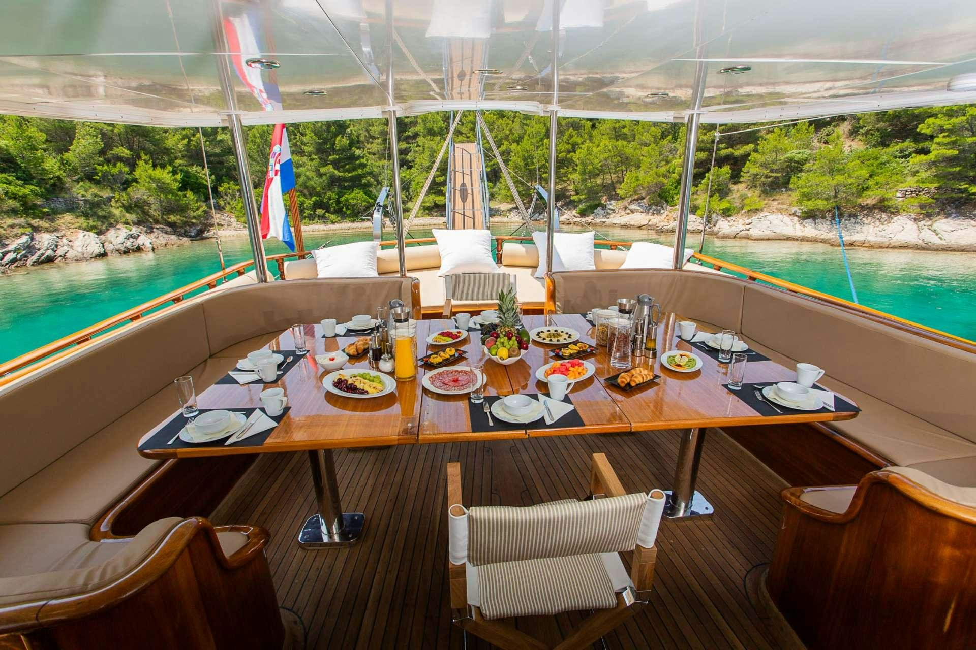 a table set for a meal aboard DOLCE VITA Yacht for Charter