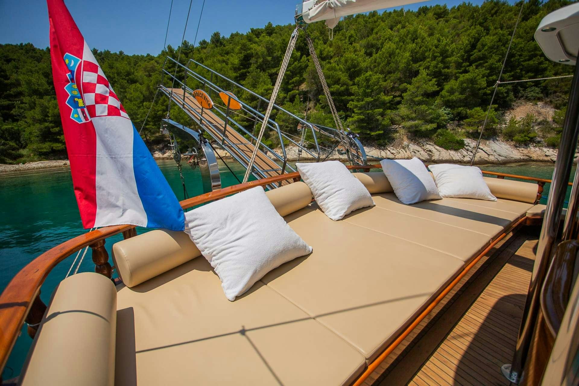 a boat with a flag on it aboard DOLCE VITA Yacht for Charter