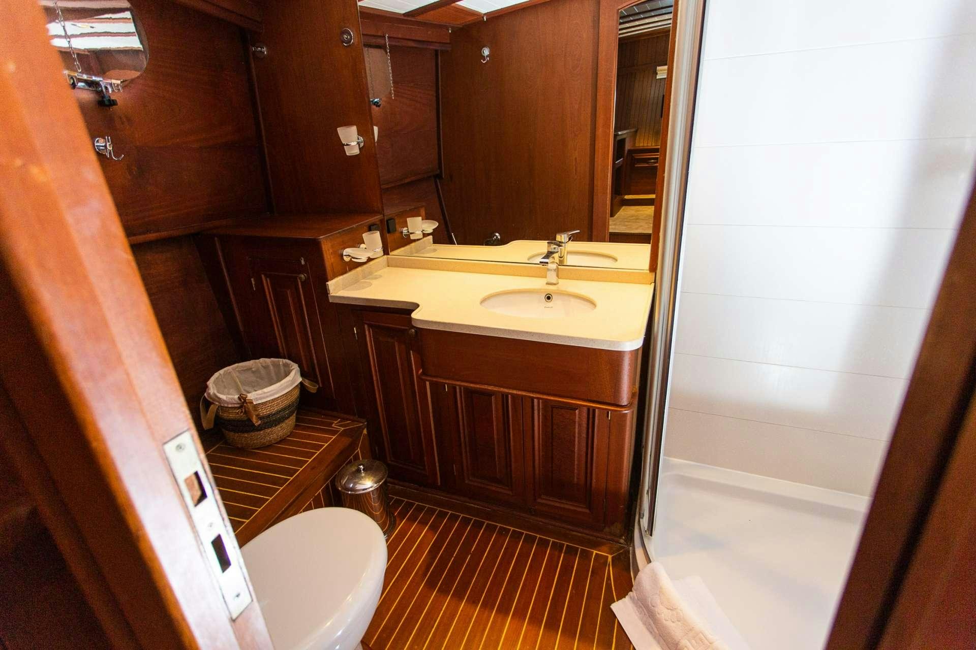 a bathroom with a sink and a mirror aboard DOLCE VITA Yacht for Charter
