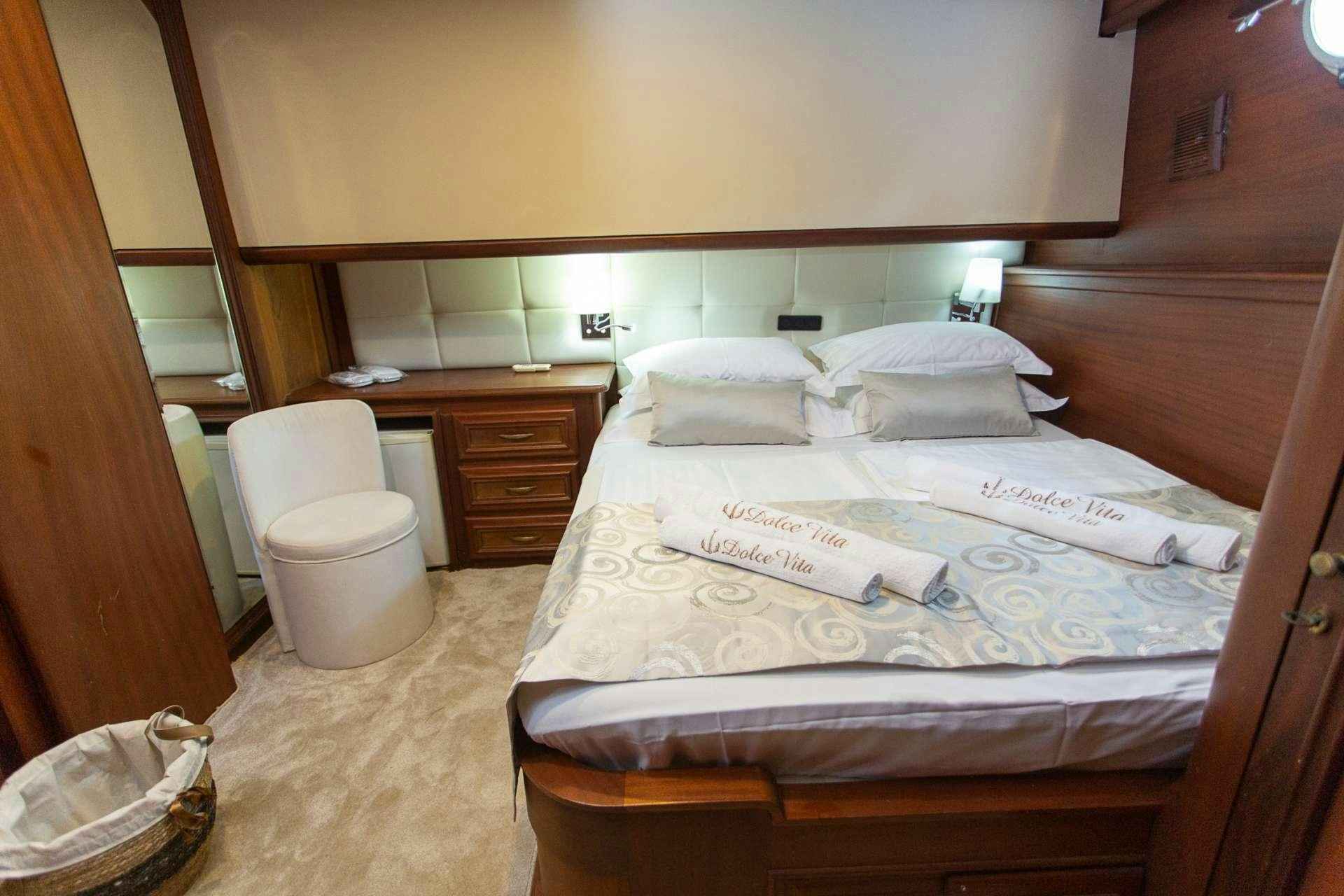 a couple of beds in a hotel room aboard DOLCE VITA Yacht for Charter