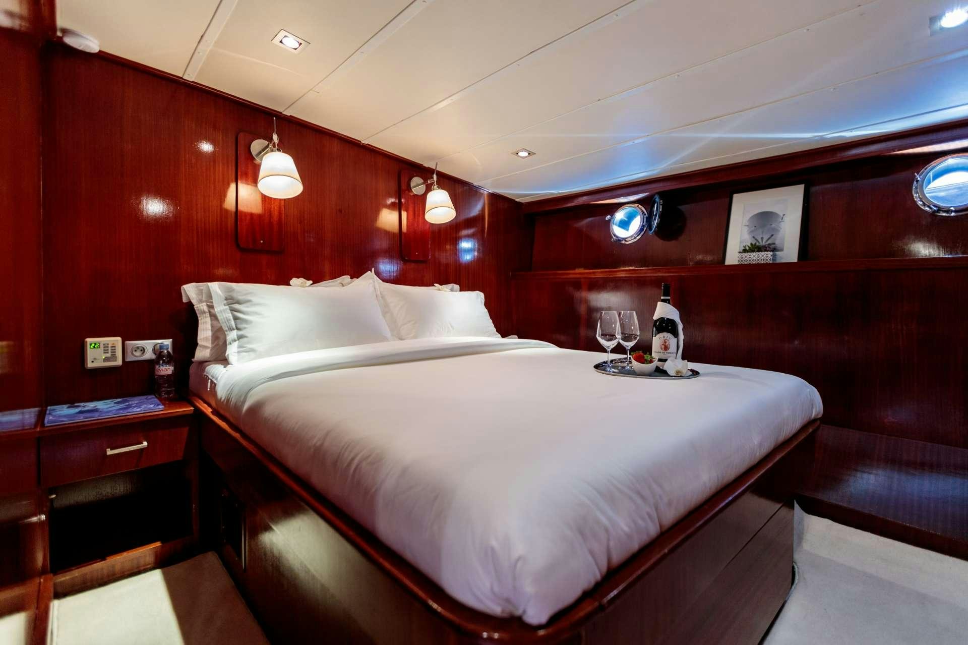 a bed with white sheets and pillows aboard VITA DOLCE Yacht for Charter