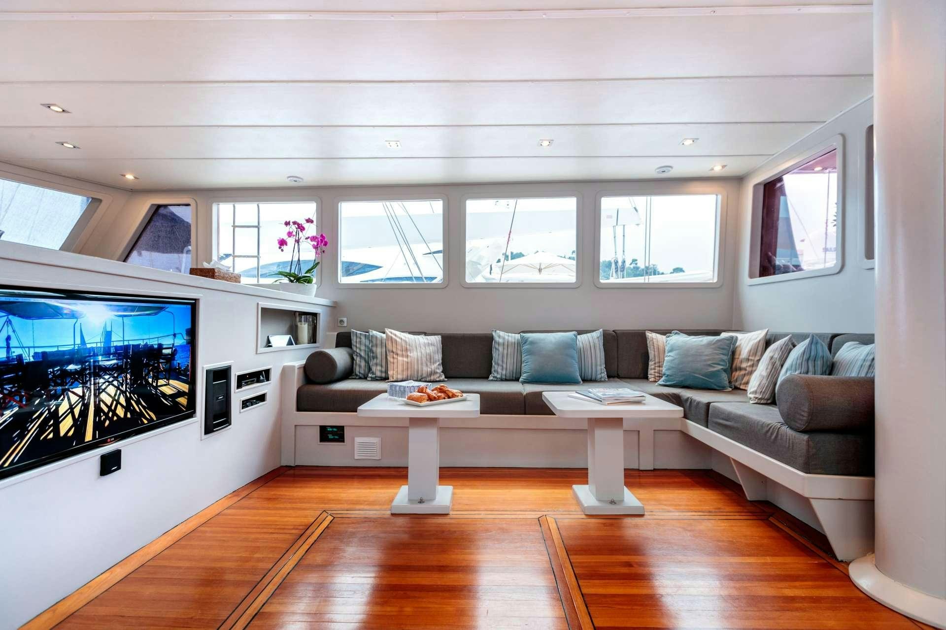 a living room with a large screen aboard VITA DOLCE Yacht for Charter
