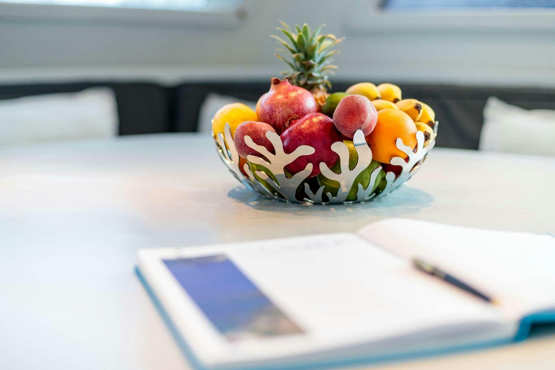 a bowl of fruit on a table aboard VITA DOLCE Yacht for Charter