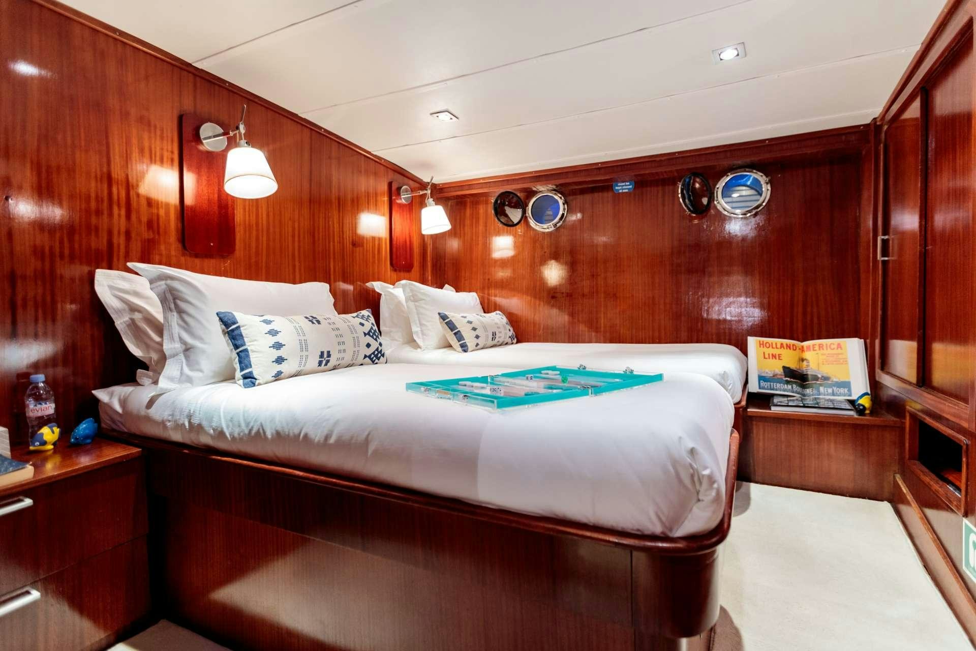 a bed with a wooden wall aboard VITA DOLCE Yacht for Charter