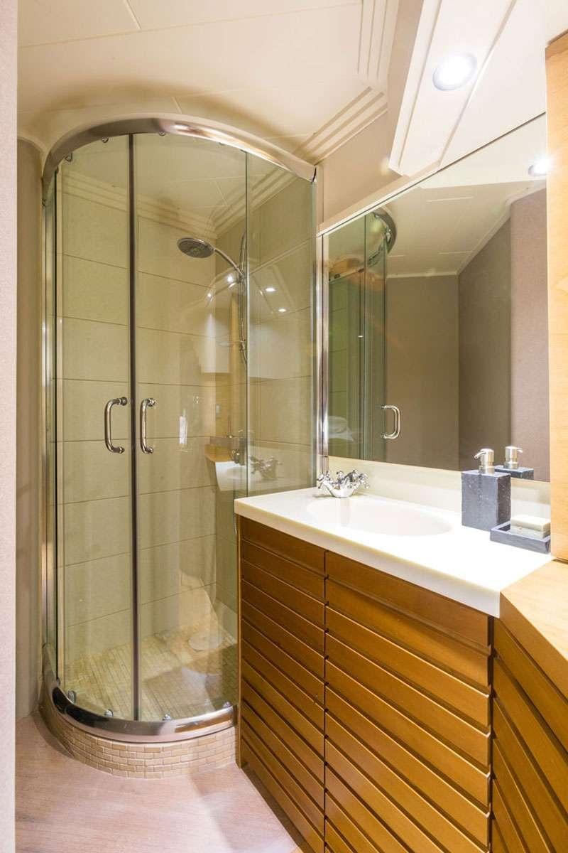 a bathroom with a glass shower aboard HEESEN Yacht for Charter