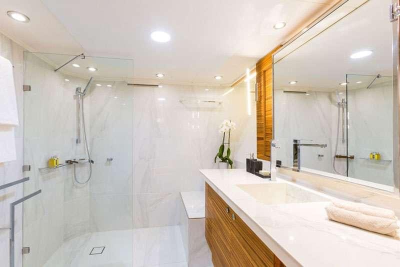 a bathroom with a large shower aboard HEESEN Yacht for Charter