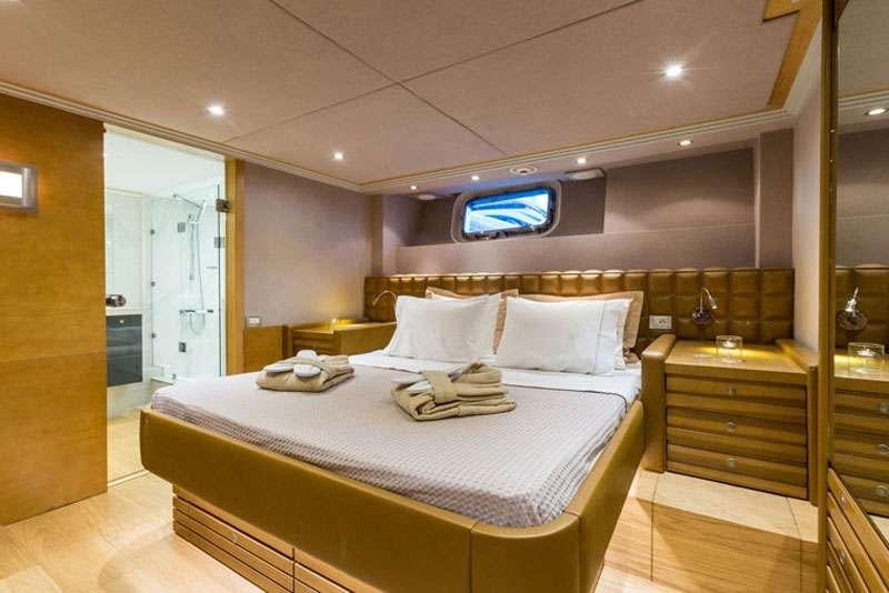 a hotel room with a bed aboard HEESEN Yacht for Charter