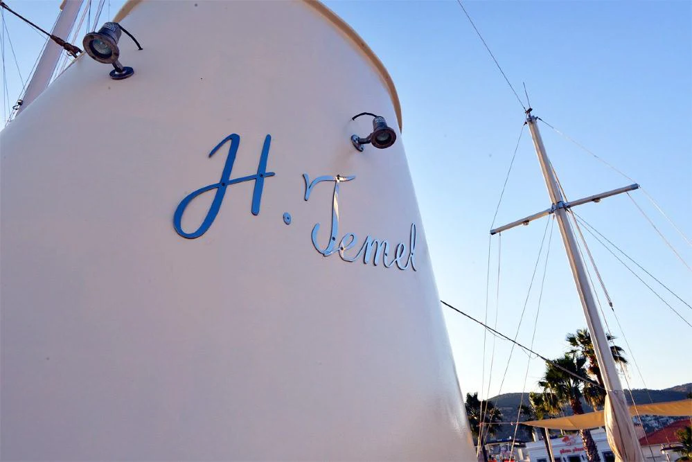 a white sign with blue lettering aboard ELARA 1 Yacht for Charter