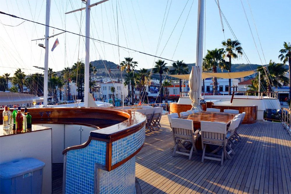a patio with tables and chairs aboard ELARA 1 Yacht for Charter