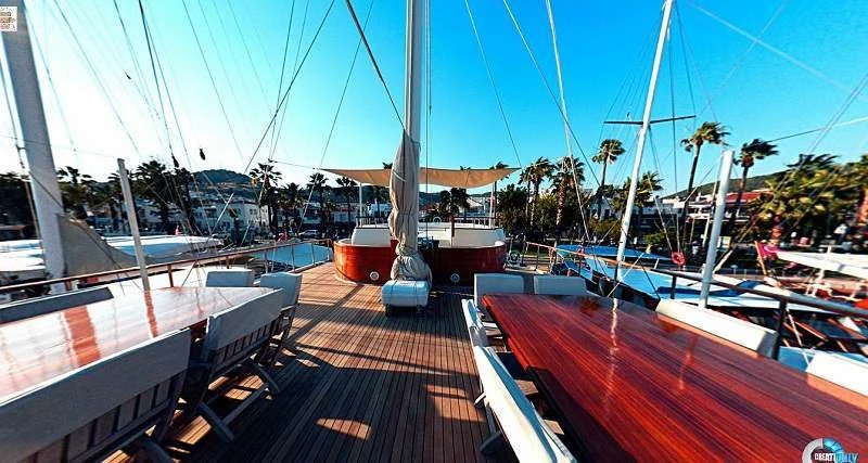 a deck with a deck and chairs aboard ELARA 1 Yacht for Charter
