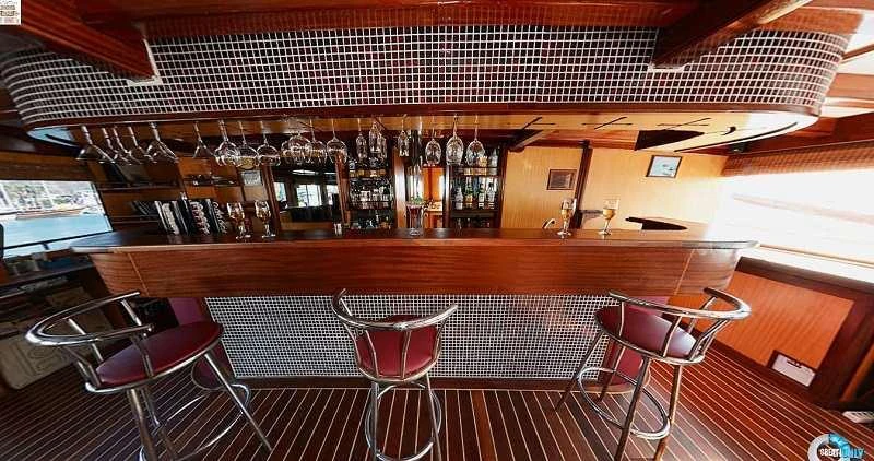 a bar with a table and chairs aboard ELARA 1 Yacht for Charter