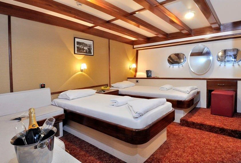 a room with a couple of beds aboard ELARA 1 Yacht for Charter