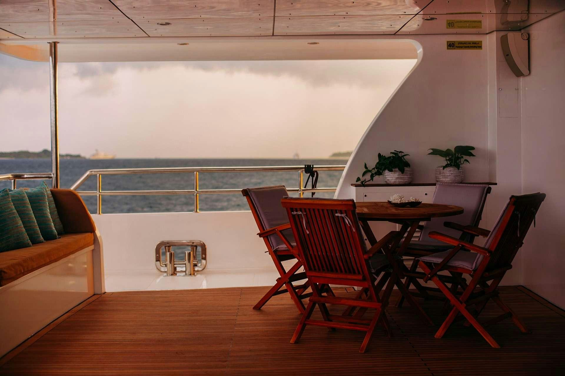 a room with a table and chairs aboard ALICE Yacht for Charter