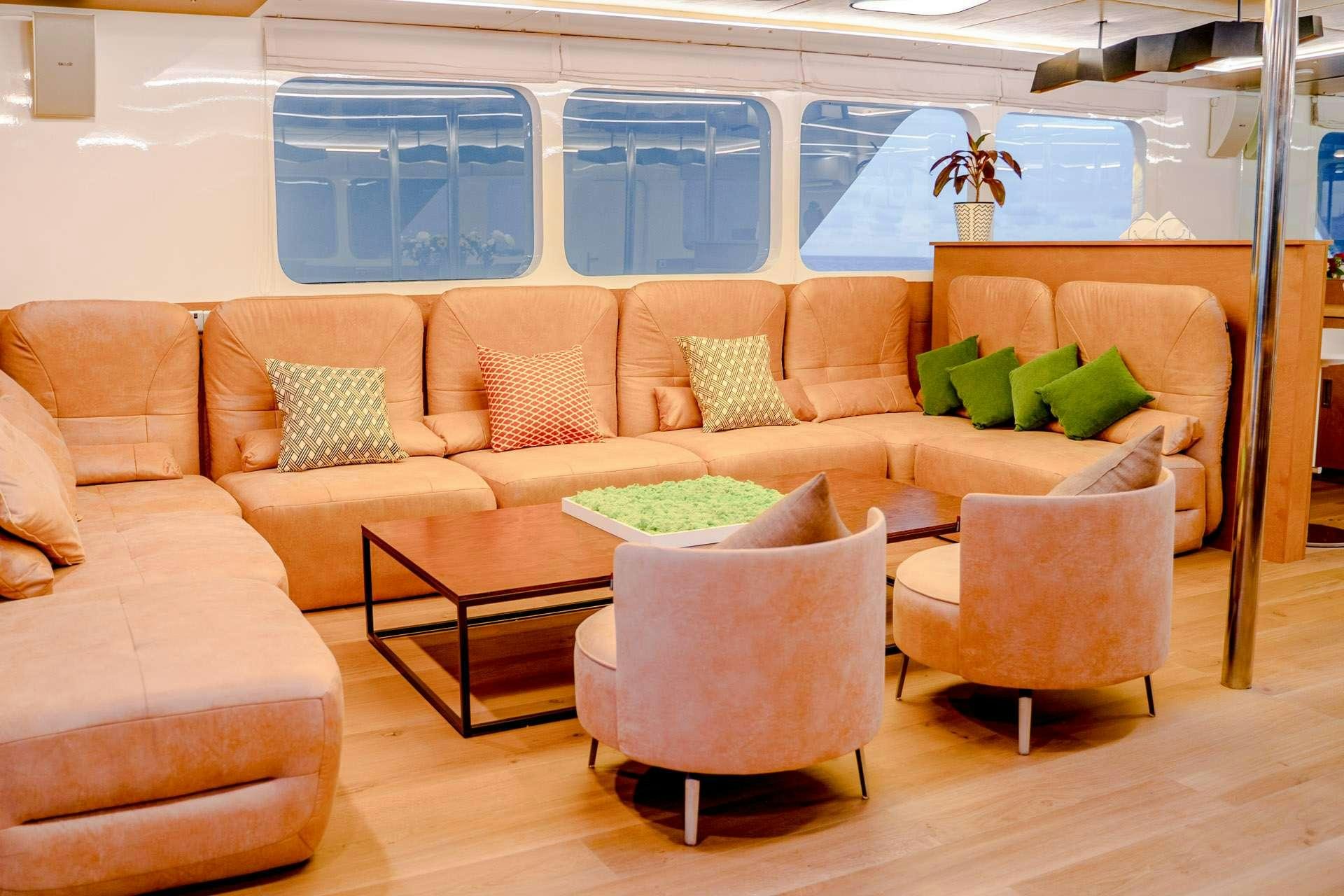 a group of couches in a room aboard ALICE Yacht for Charter