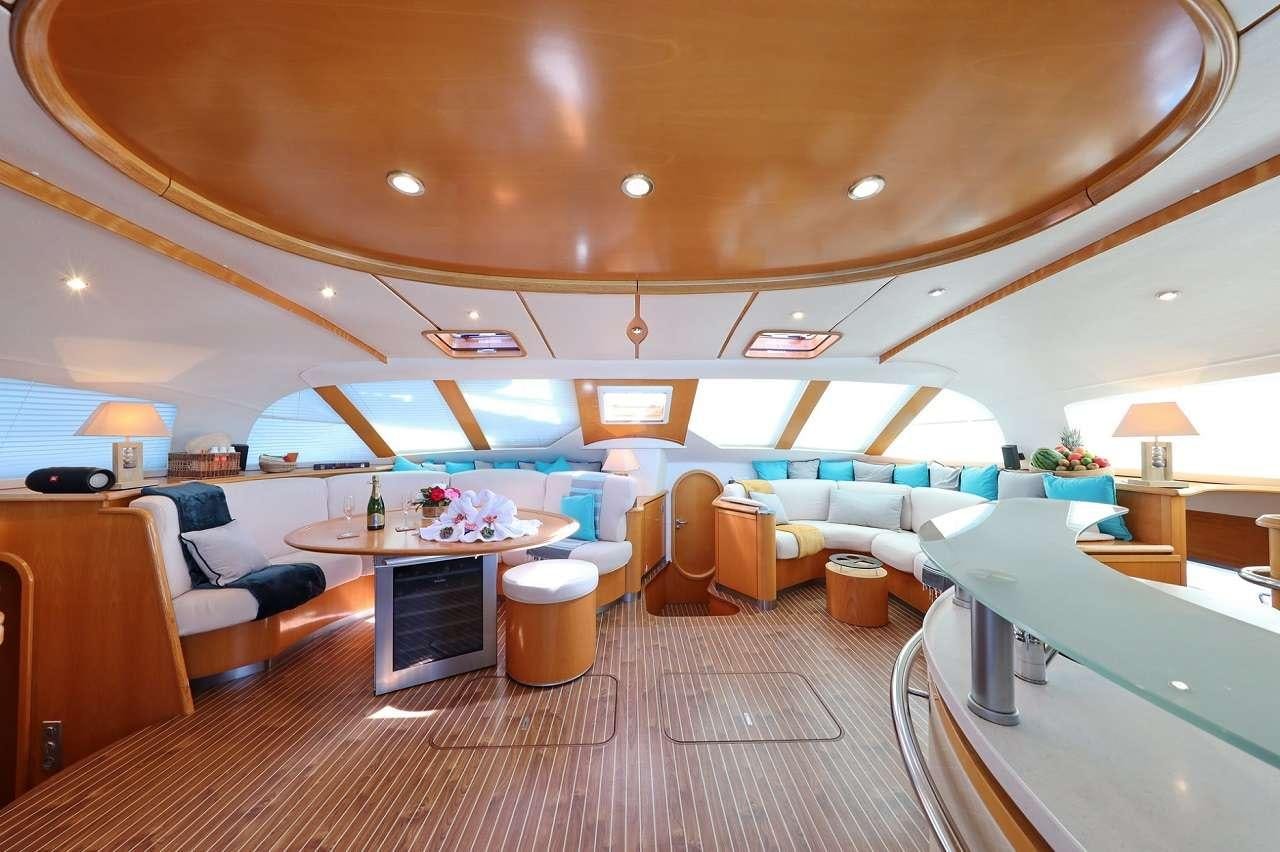 a room with a couch and a table aboard OCEAN MED Yacht for Charter