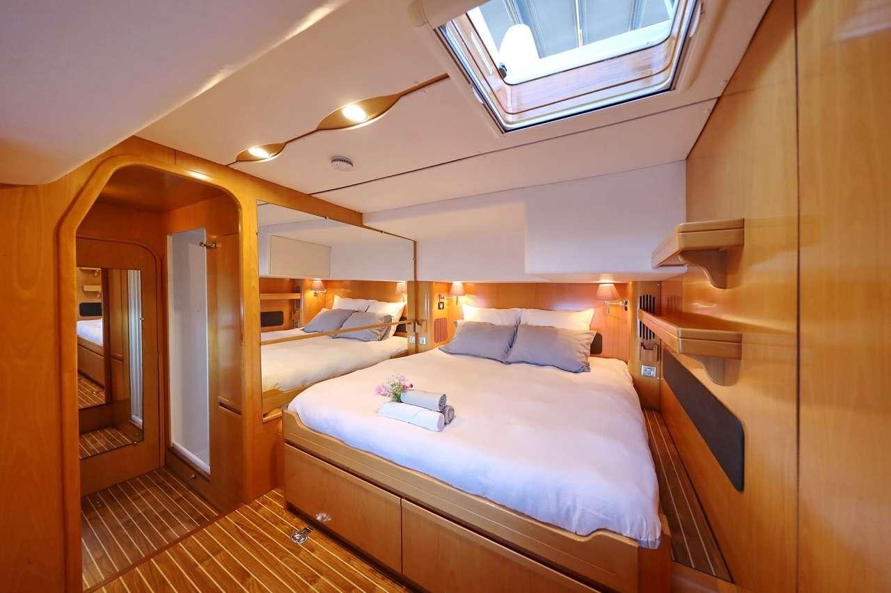 a room with a bed and a desk aboard OCEAN MED Yacht for Charter