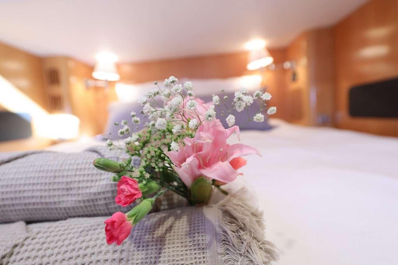 a bouquet of flowers on a couch aboard OCEAN MED Yacht for Charter