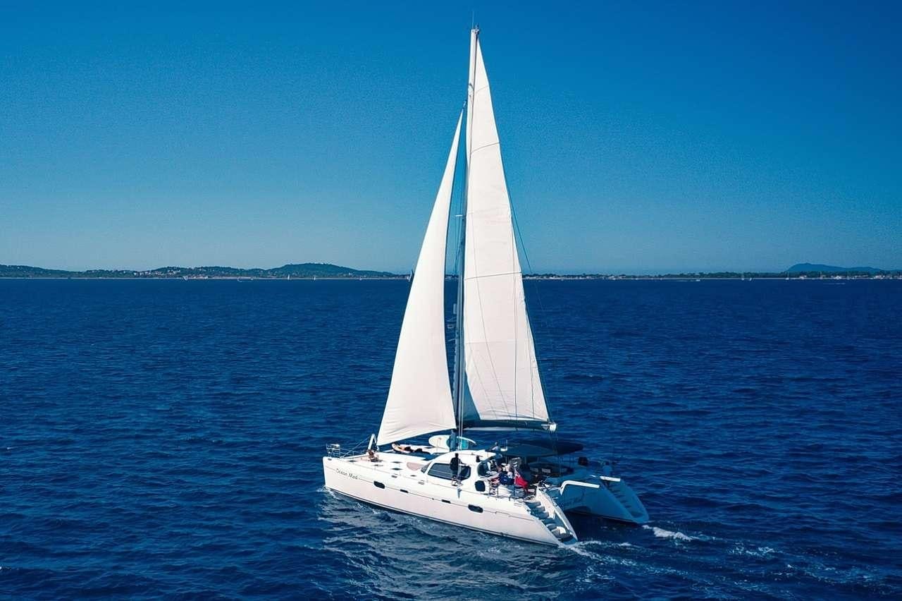a white sailboat on the water aboard OCEAN MED Yacht for Charter