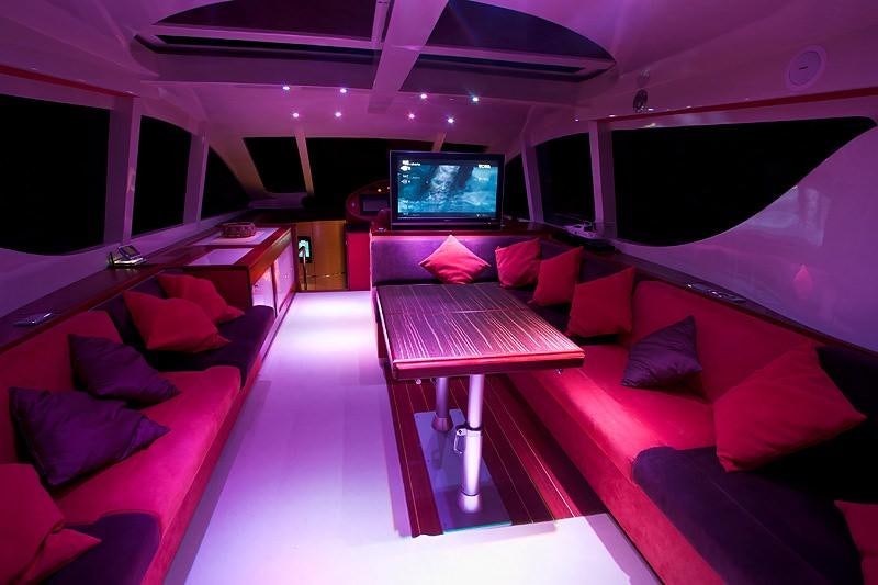 a room with a couch and a television aboard SAURON Yacht for Charter