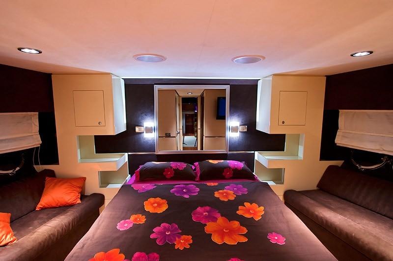 a living room with a couch and a television aboard SAURON Yacht for Charter