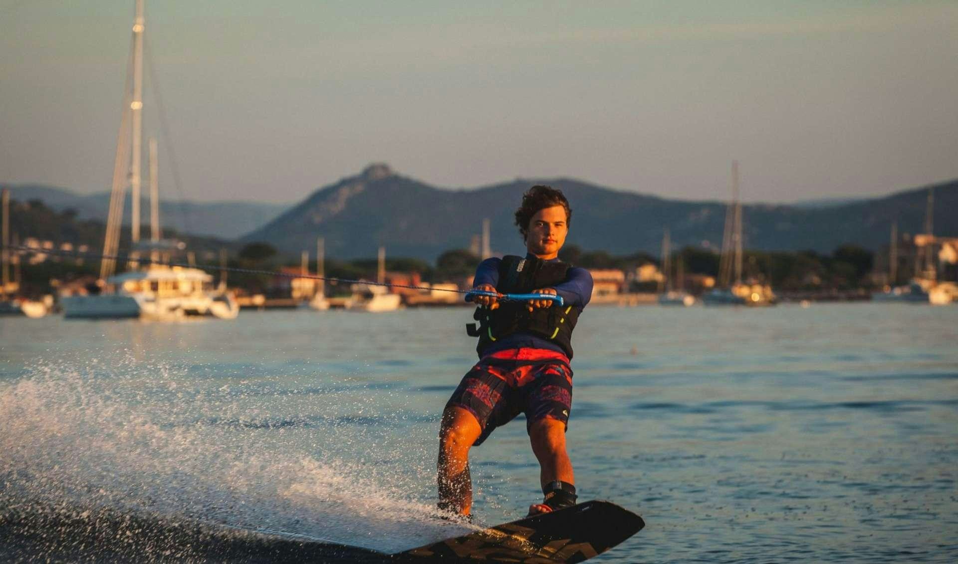 a man is water skiing aboard OCEAN VIEW Yacht for Charter