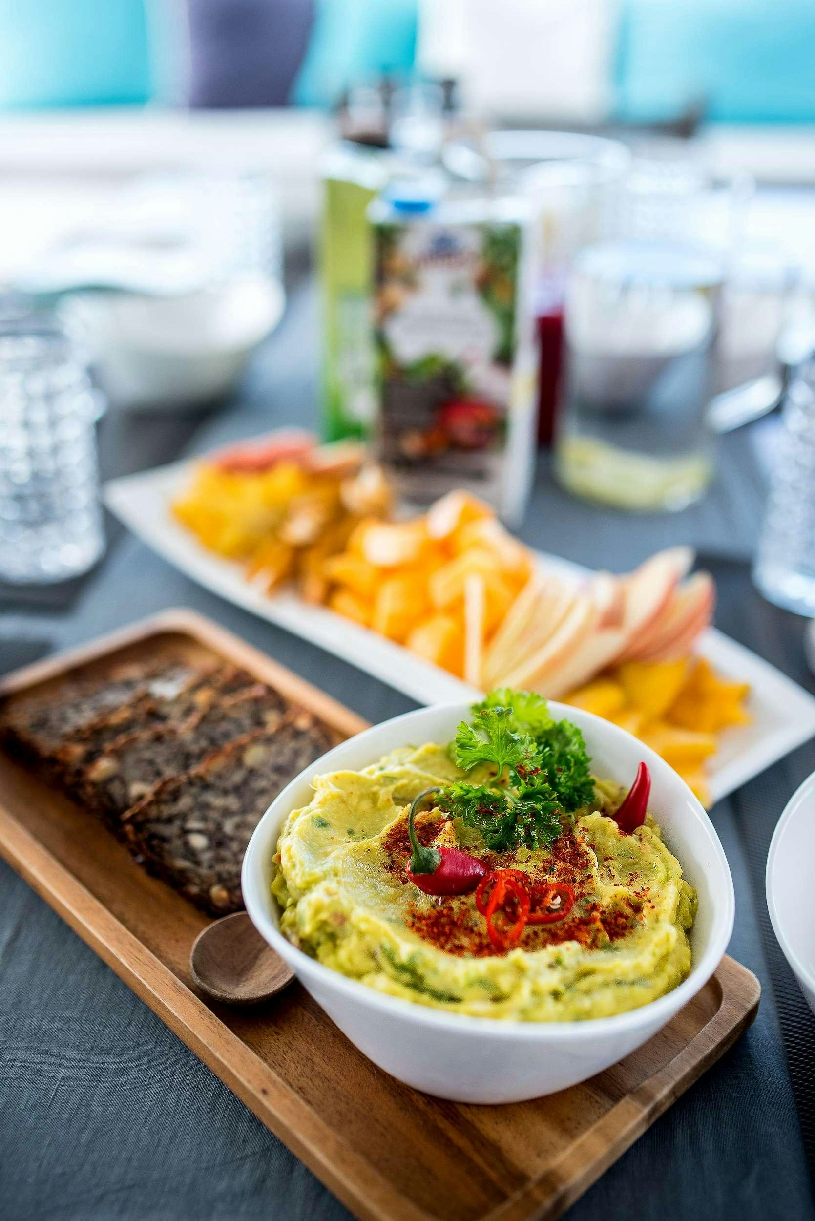 a table with plates of food and glasses of water aboard OCEAN VIEW Yacht for Charter