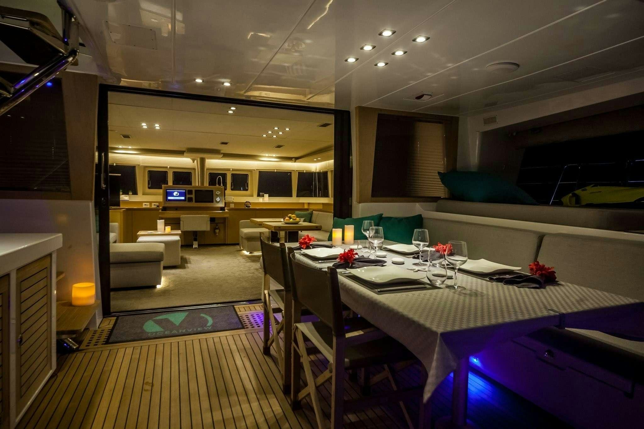 a room with tables and chairs aboard OCEAN VIEW Yacht for Charter