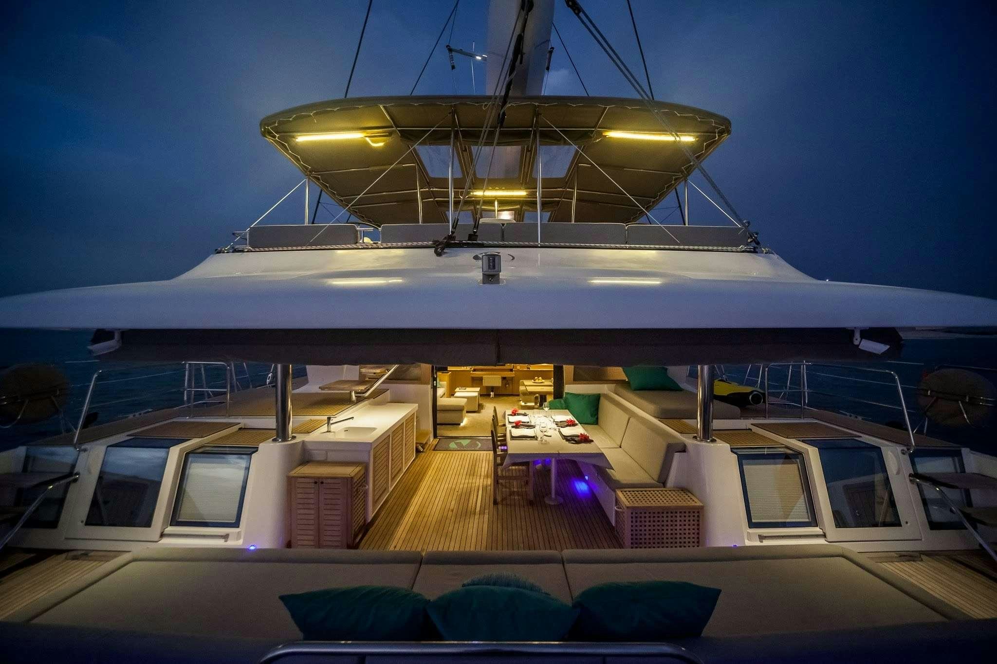 a large white building with a spiral staircase and a large fan aboard OCEAN VIEW Yacht for Charter