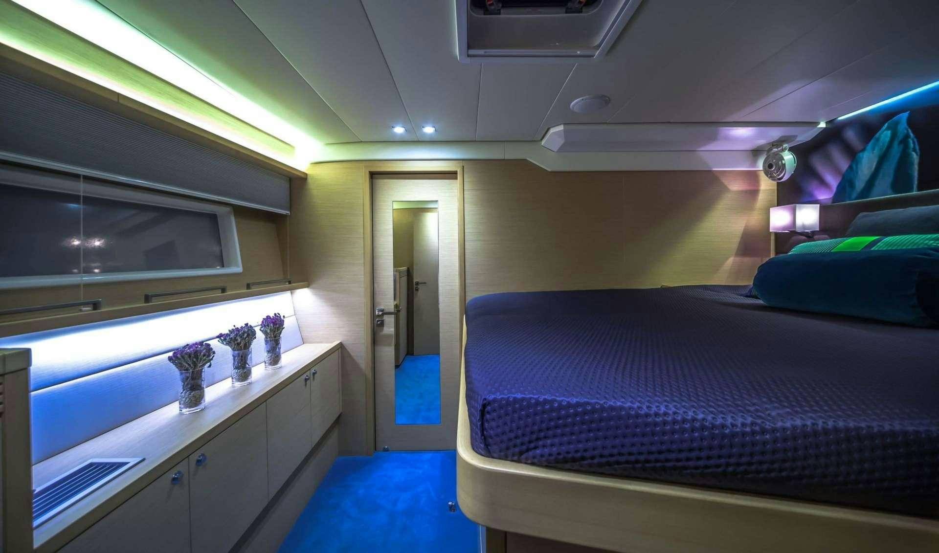 a bedroom with a bed and a desk aboard OCEAN VIEW Yacht for Charter