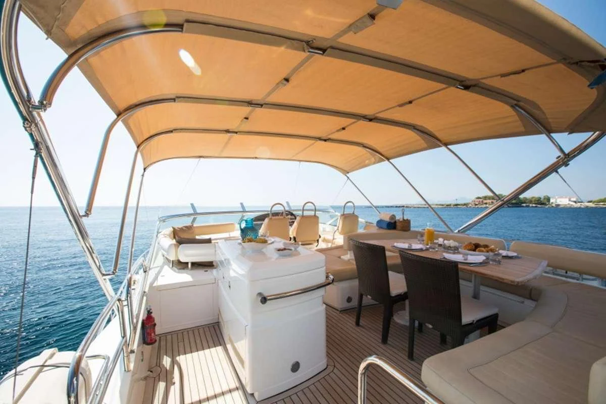 a boat with a table and chairs aboard D5 Yacht for Charter