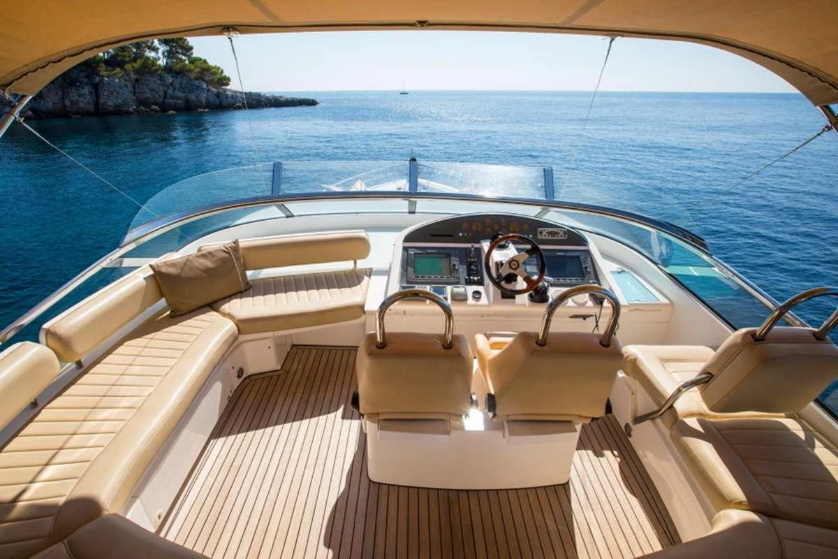 a boat with a steering wheel and seats on the deck aboard D5 Yacht for Charter