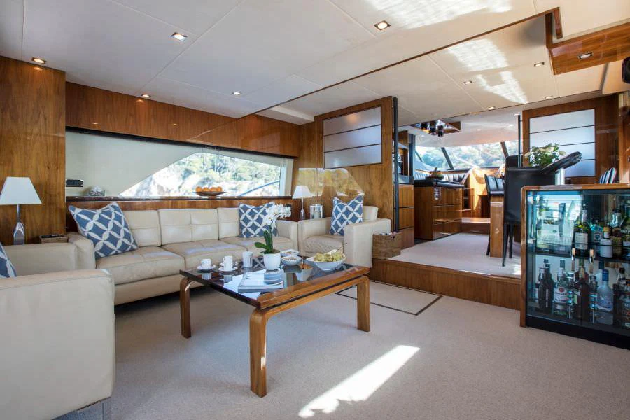 a living room with a large screen aboard D5 Yacht for Charter